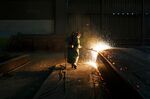 Sparks fly as an employee performs a quality check on a steel slab at the Stelco Holdings Inc. plant in Nanticoke, Ontario, Canada.