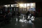 Families wait with their children in the observation area after receiving doses of the Pfizer-BioNTech Covid-19 vaccine at a clinic at Hazel Park High School in Hazel Park, Michigan, U.S., on Nov. 8.
