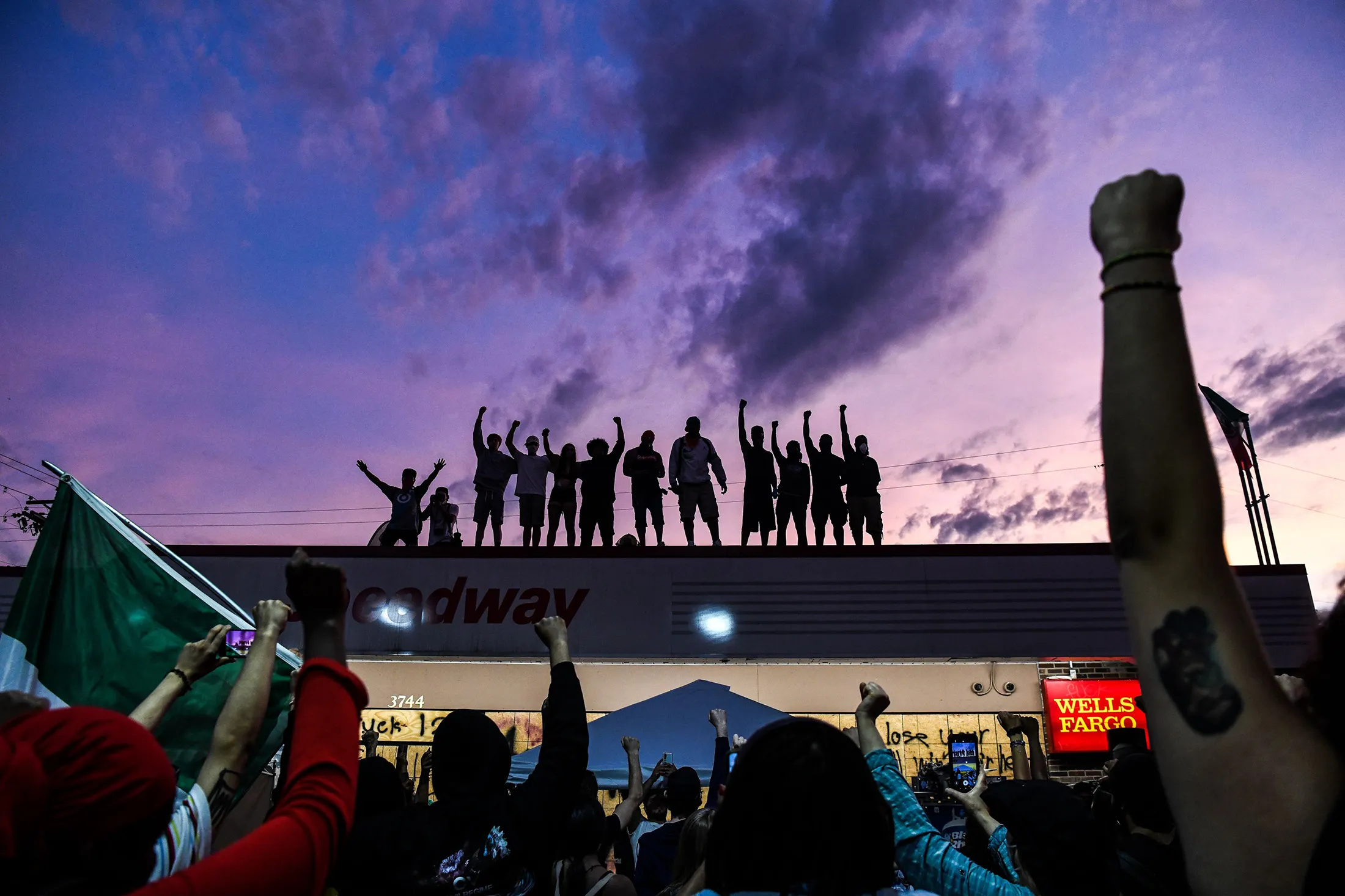 People raise their hands and shout slogans as they protest at the makeshift memorial in honour of George Floyd, in Minneapolis, Minnesota, on June 2.