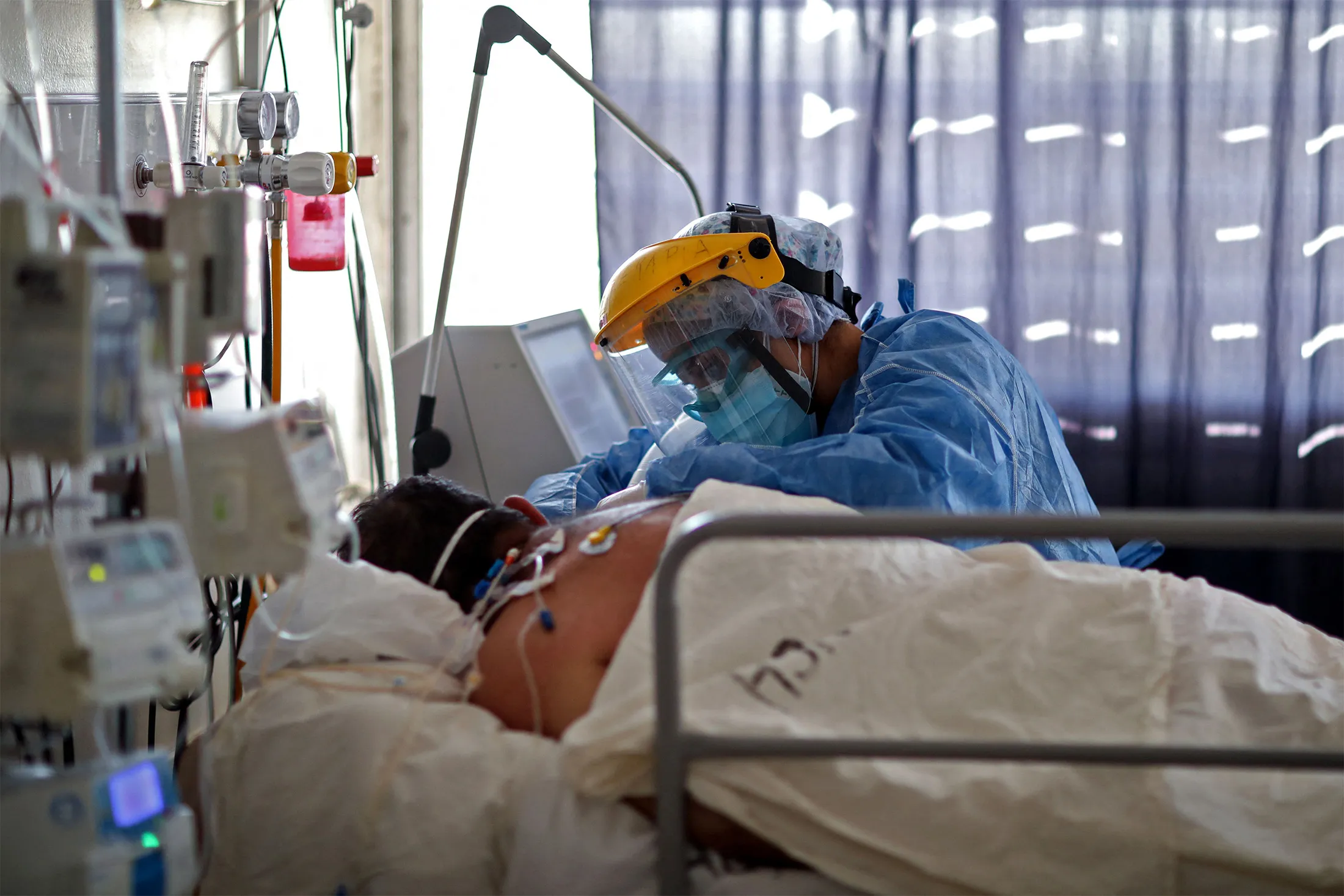 A health worker checks on a patient suffering from Covid-19 at the ICU of the a hospital in Cordoba, Argentina, on July 6.