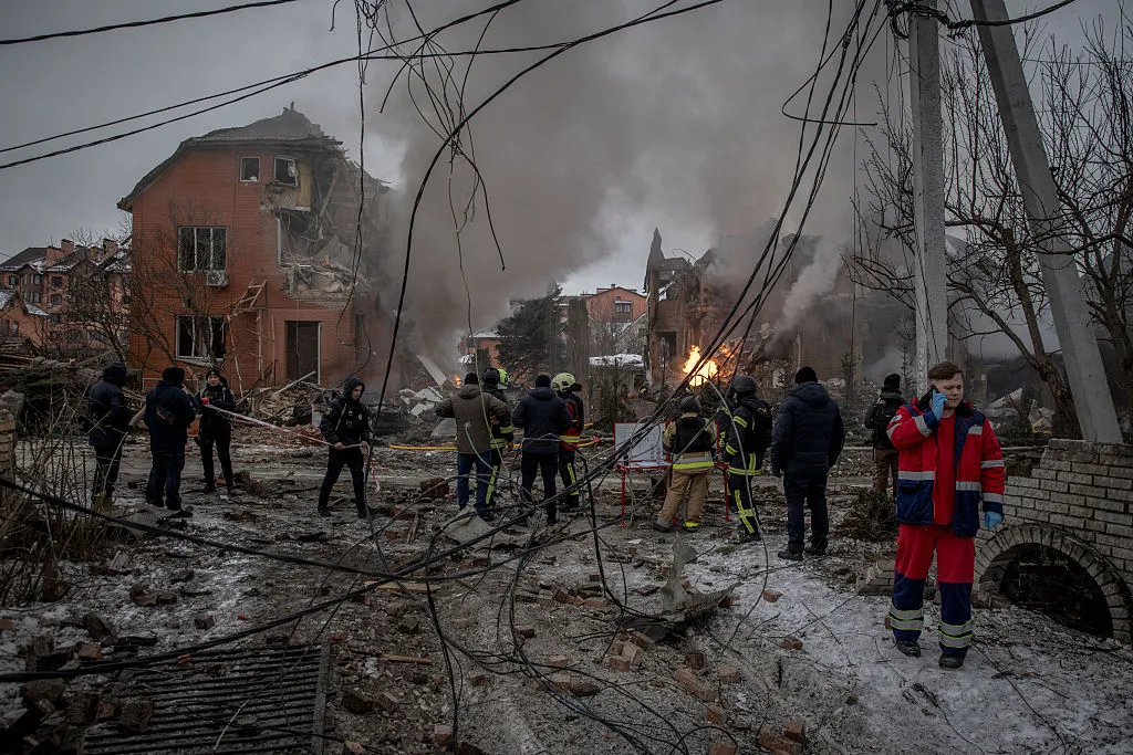 First responders work at the site of a Russian attack in Kyiv, on Feb. 22.