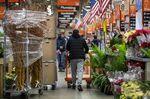 A customer pushes a cart past flowers for sale at a Home Depot Inc. store in Chicago, Illinois, U.S., on Monday, Nov. 23, 2020.