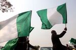 Nigerian lawyers hold up the national flag in Abuja.