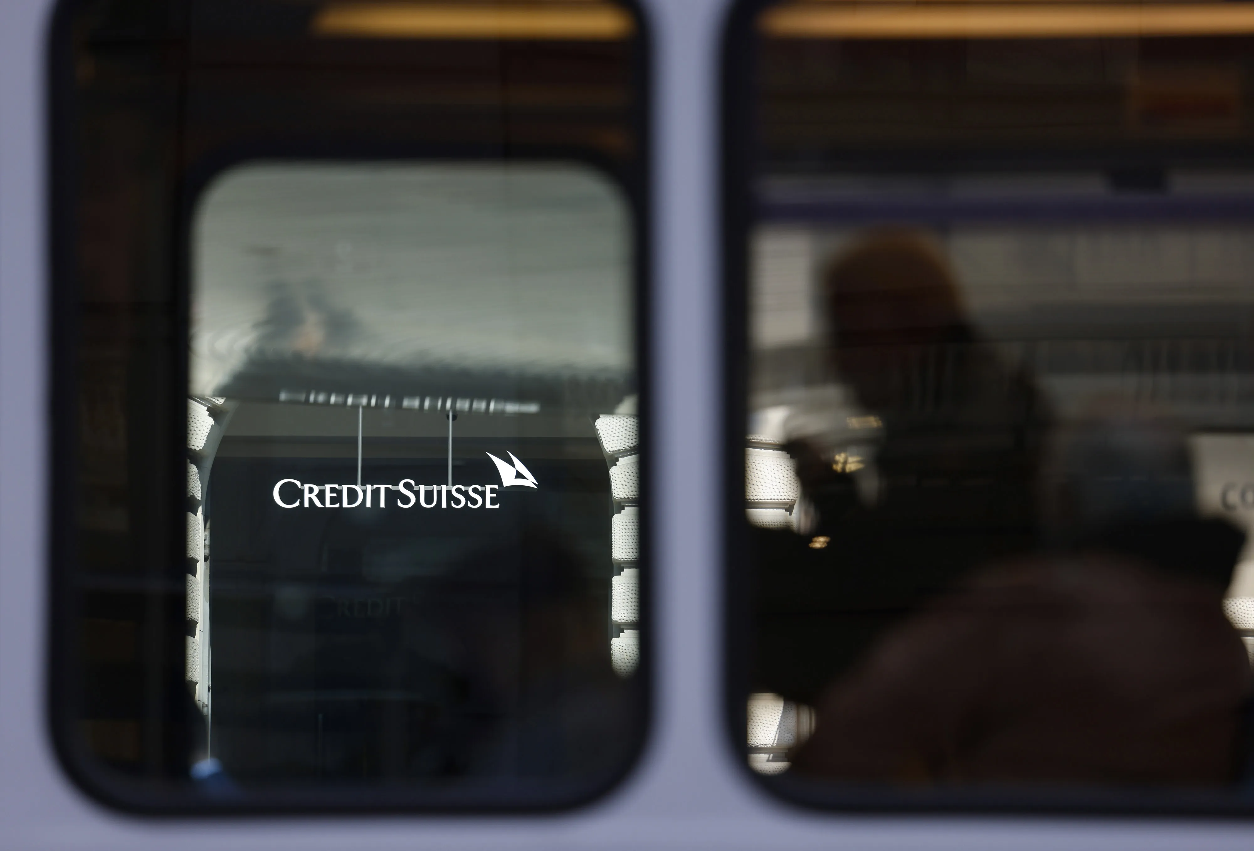A tram travels by the Credit Suisse headquarters in Zurich.