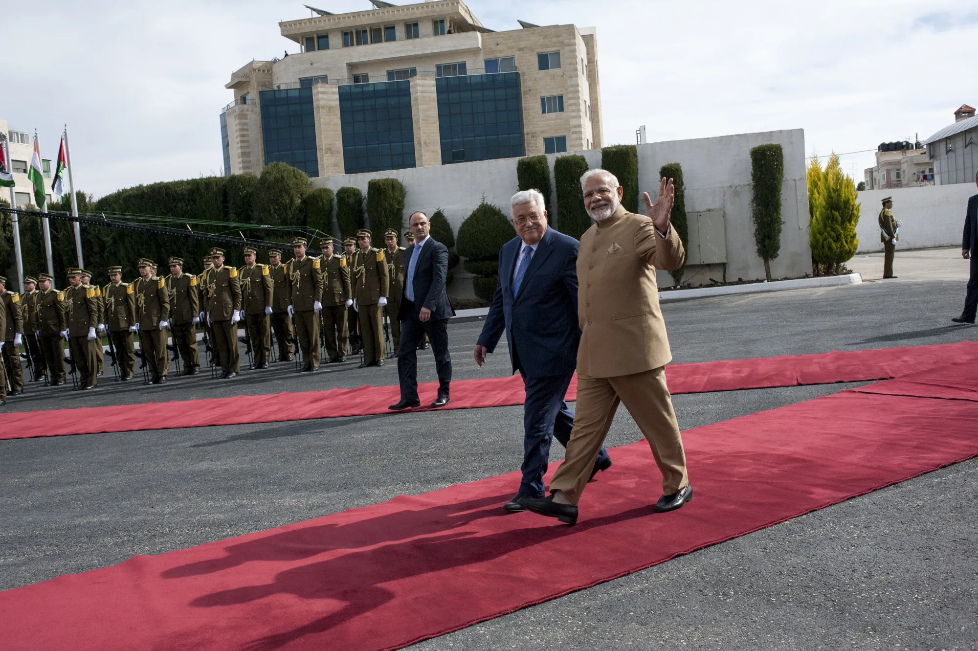 Narendra Modi, India's prime minister, right, waves as he walks with Mahmoud Abbas, Palestinian Authority president, at the presidential headquarters in Ramallah, West Bank, on&nbsp;Feb. 10.