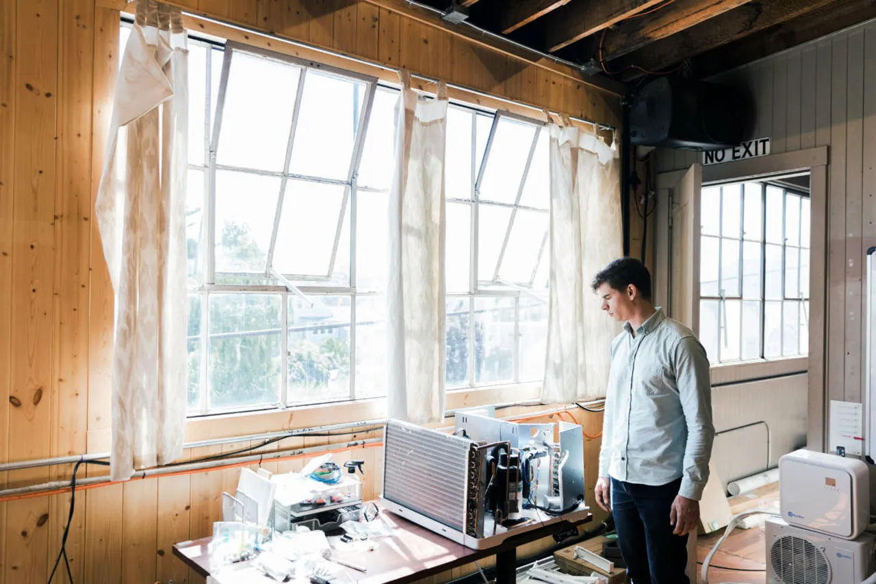 Treau CEO Vince Romanin looks over their prototype low-carbon air conditioner.