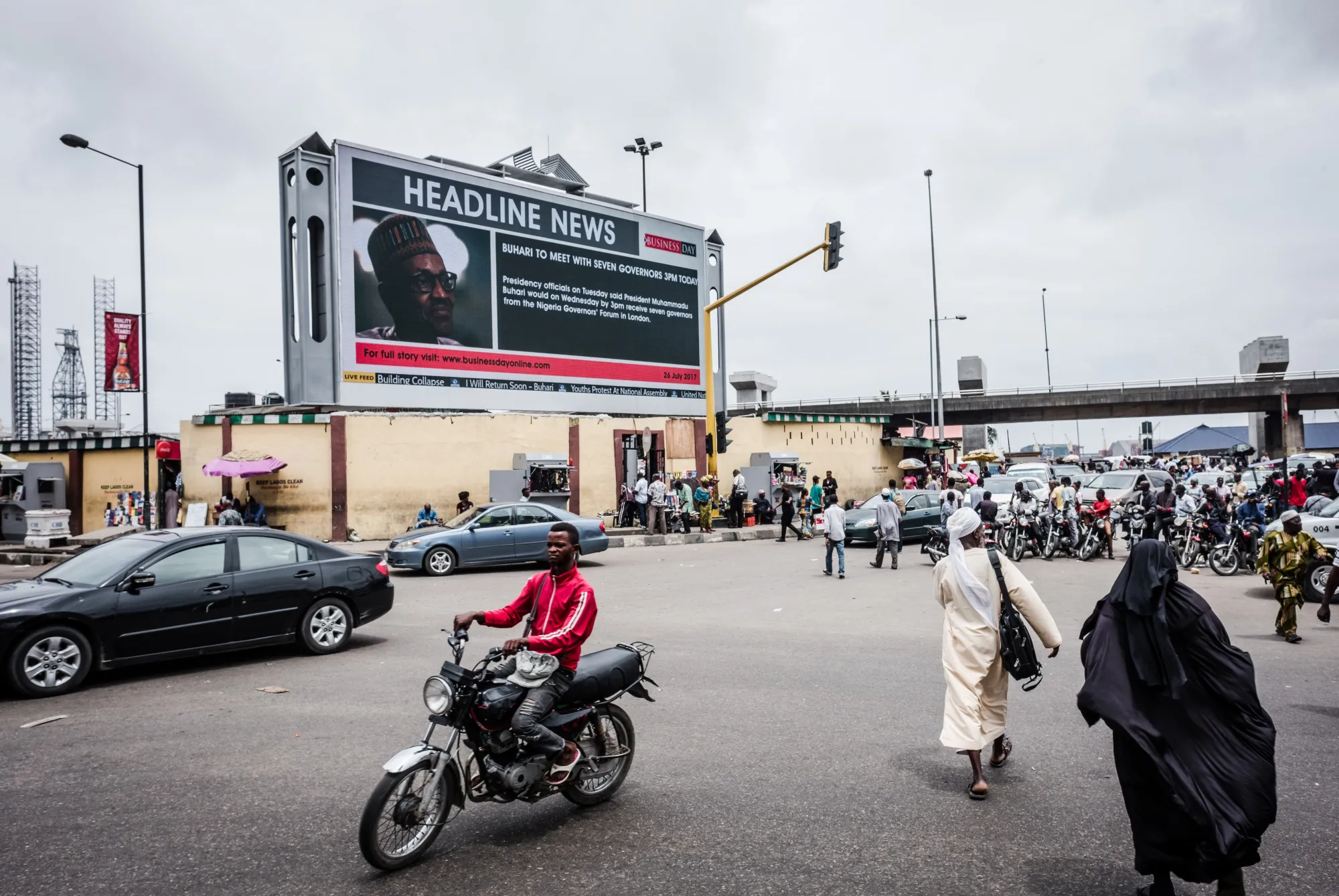 A giant electronic advertising screen displays headline news about President Muhammadu Buhari in Lagos.