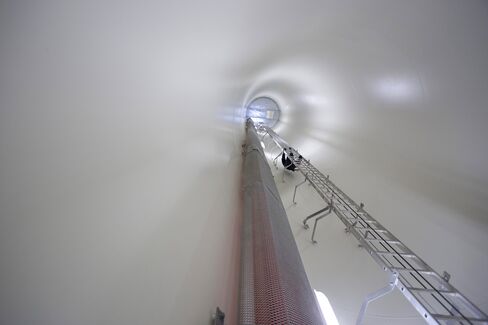 A GE technician climbs up a section of a turbine at the Colorado Highlands Wind Farm in Fleming.