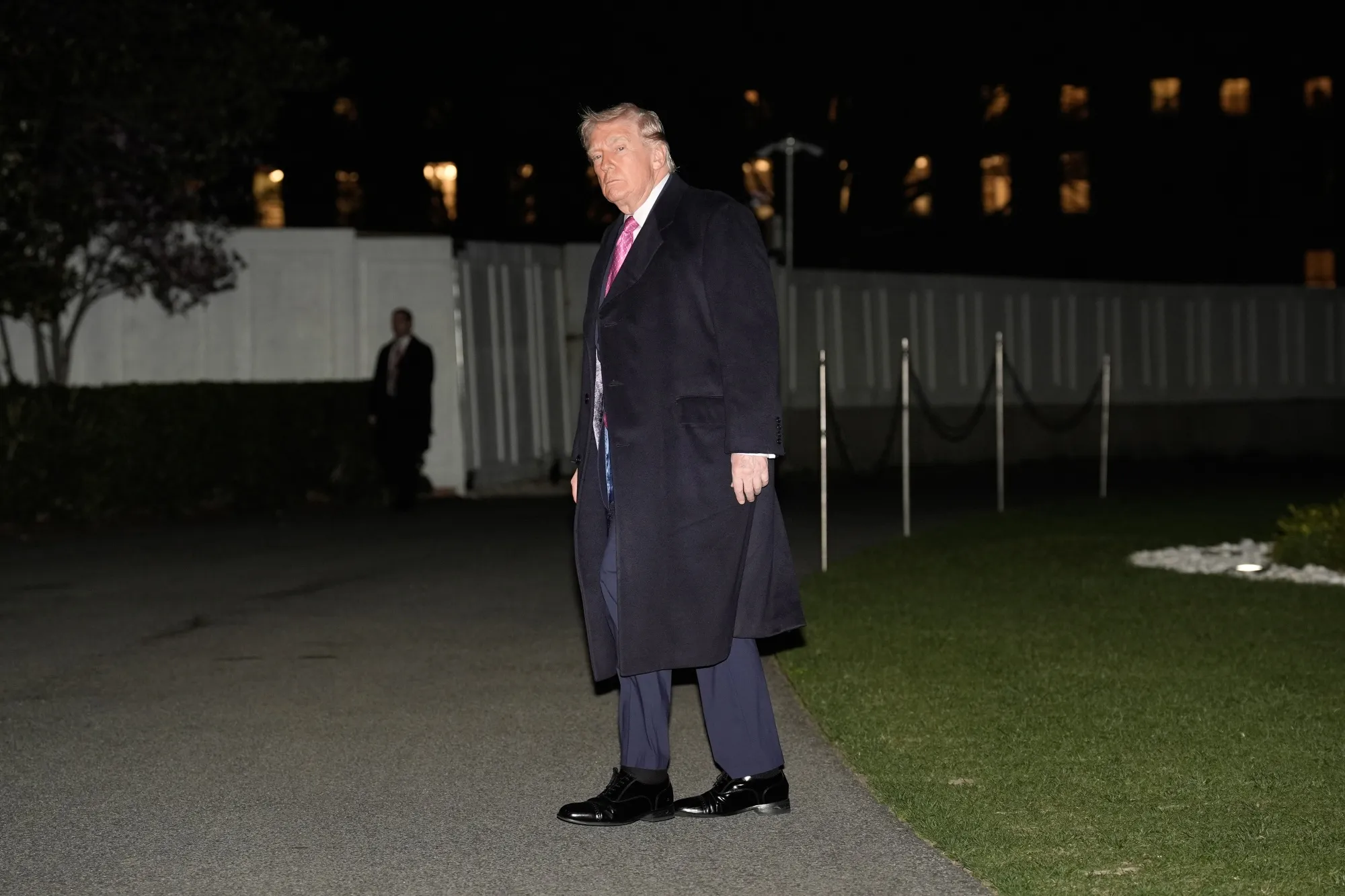 US President Donald Trump walks on the South Lawn of the White House after arriving Sunday.