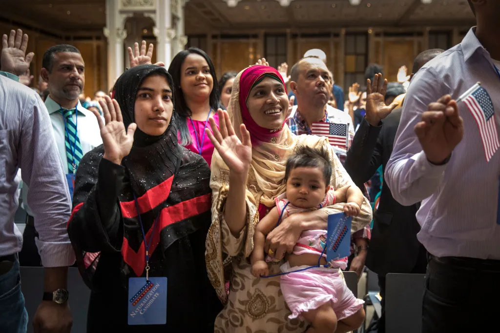 New U.S. citizens&nbsp;recite&nbsp;the Oath of Allegiance during naturalization ceremony at the New York Public Library.