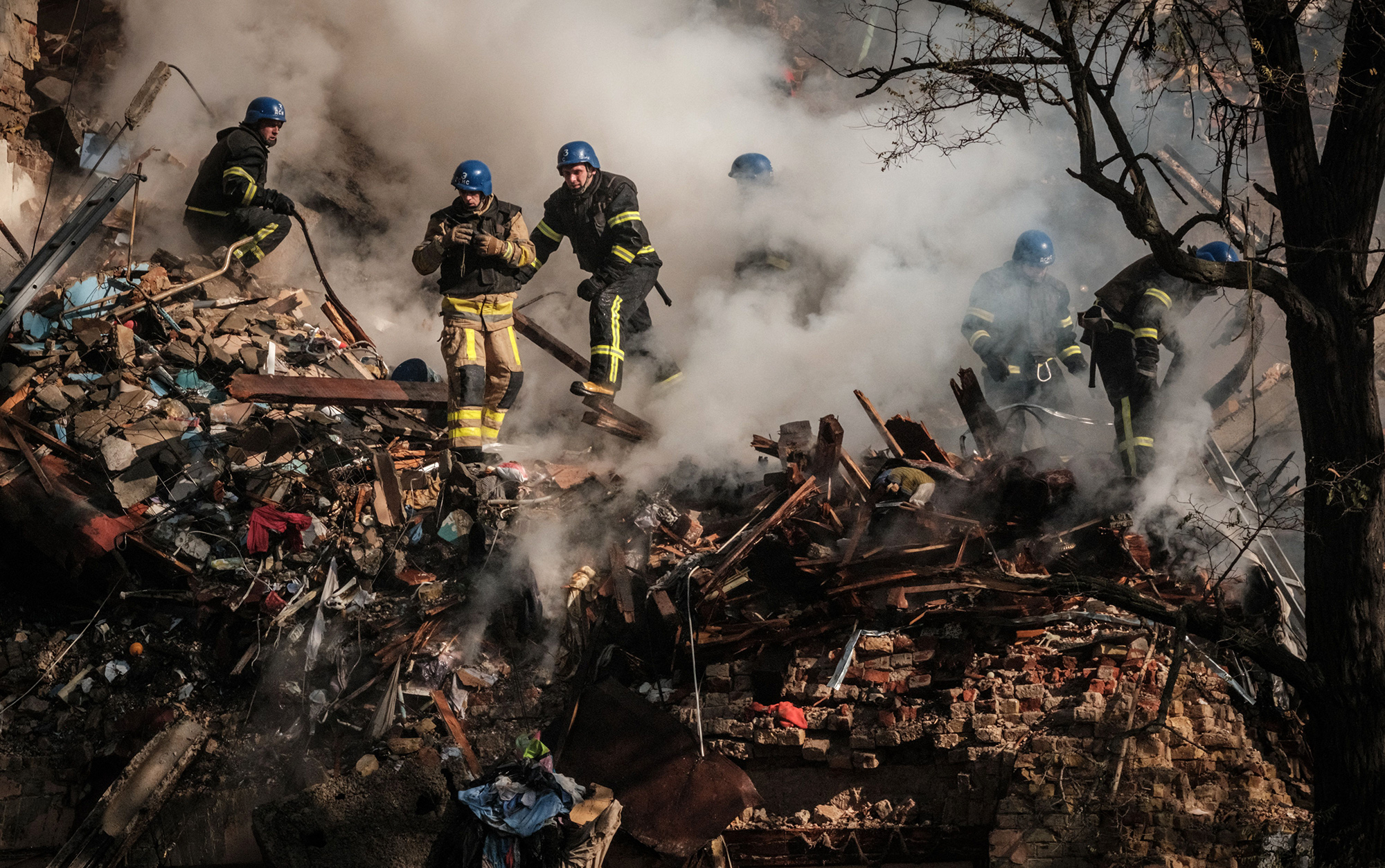 Ukrainian firefighters in the rubble of&nbsp;a destroyed building after a drone attack in Kyiv on Oct.&nbsp;17.&nbsp;