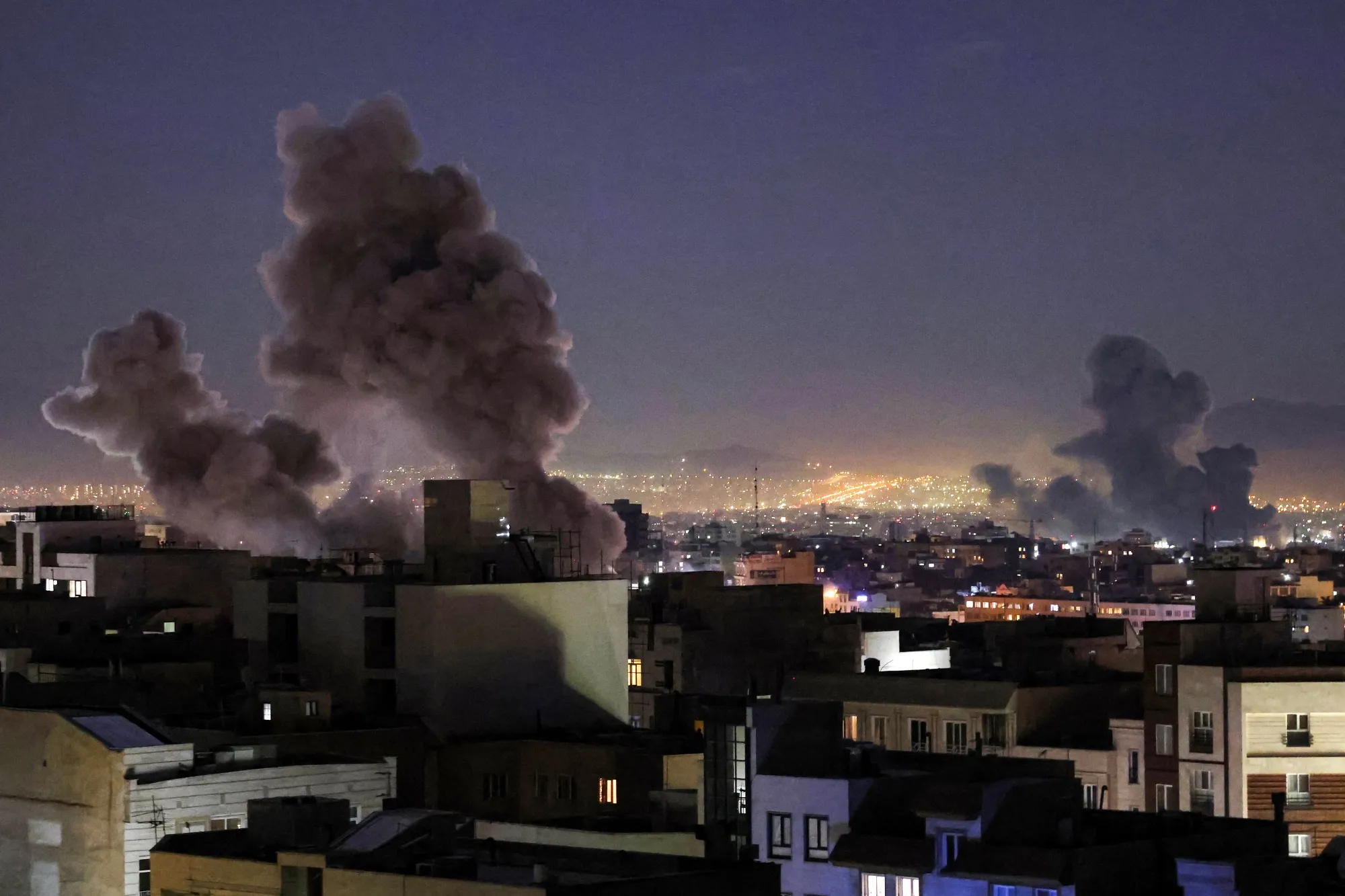 Smoke plumes rise following missile strikes in Tehran on March 1.