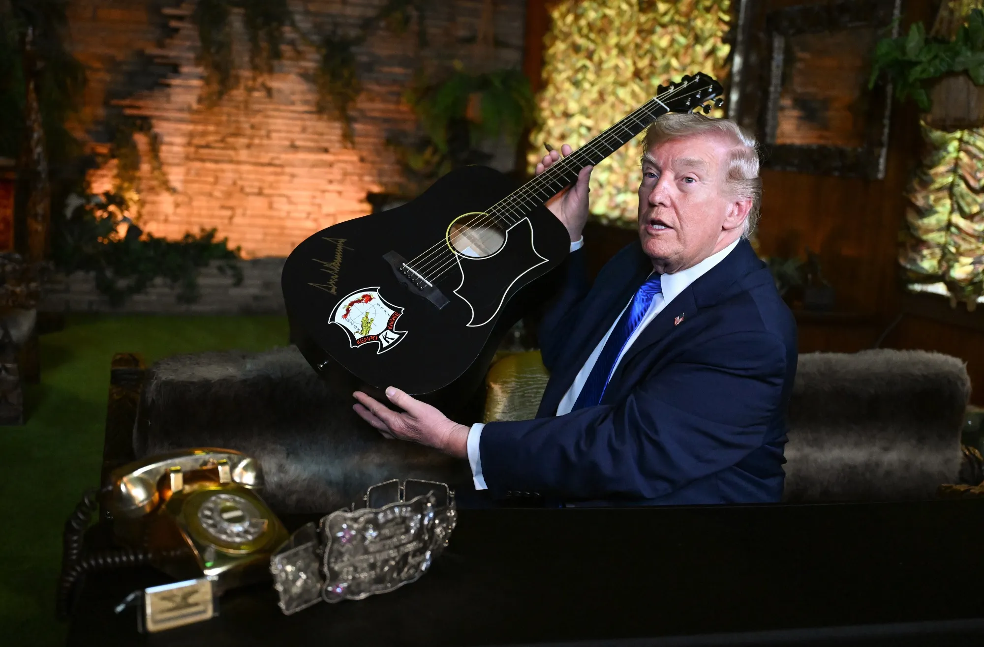 There’s a war, but sure, sign a guitar.