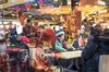 People sit in a food hall at the Yuyuan Garden ahead of the Lunar New Year in Shanghai, China, on Monday, Jan. 28, 2019. The Lunar New Year begins on Feb. 5, and marks the start of the Year of the Pig.