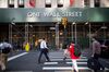 Pedestrians cross Broadway towards 1 Wall Street near the New York Stock Exchange (NYSE) in New York, U.S., on Friday, Aug. 24, 2018. U.S. stocks rose, while the dollar deepened losses and Treasuries turned higher after the Federal Reserve chair signaled the central bank has no intention of accelerating the pace of rate hikes.