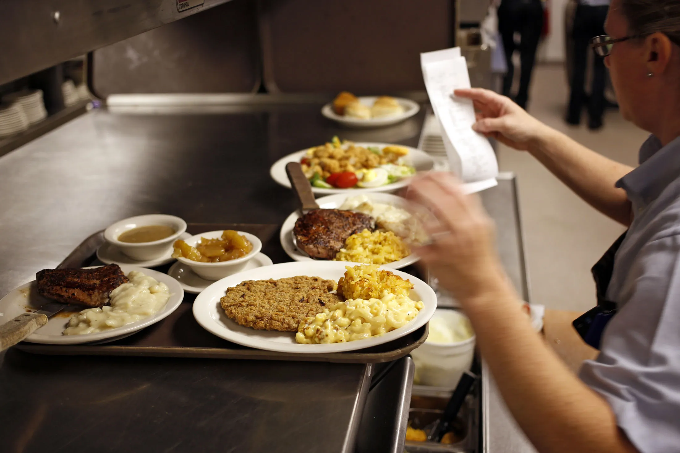 A waitress prepares an order at a Cracker Barrel Old Country Store.
