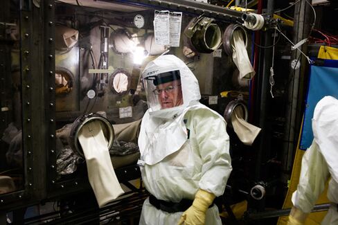 Inside the Plutonium Finishing Plant: A technician at work on a glovebox