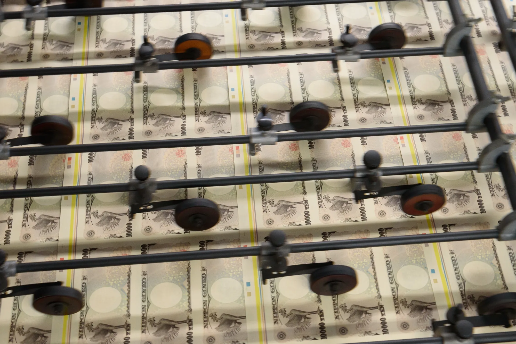 Sheets of Japanese 10,000 yen banknotes move through a machine at the National Printing Bureau Tokyo plant in Tokyo, Japan, on Monday, May 20, 2019. Japan’s unexpected growth spurt on the gross domestic product (GDP) in the first quarter masked weakness in the economy just as policy makers prepare to hike the sales tax in October.