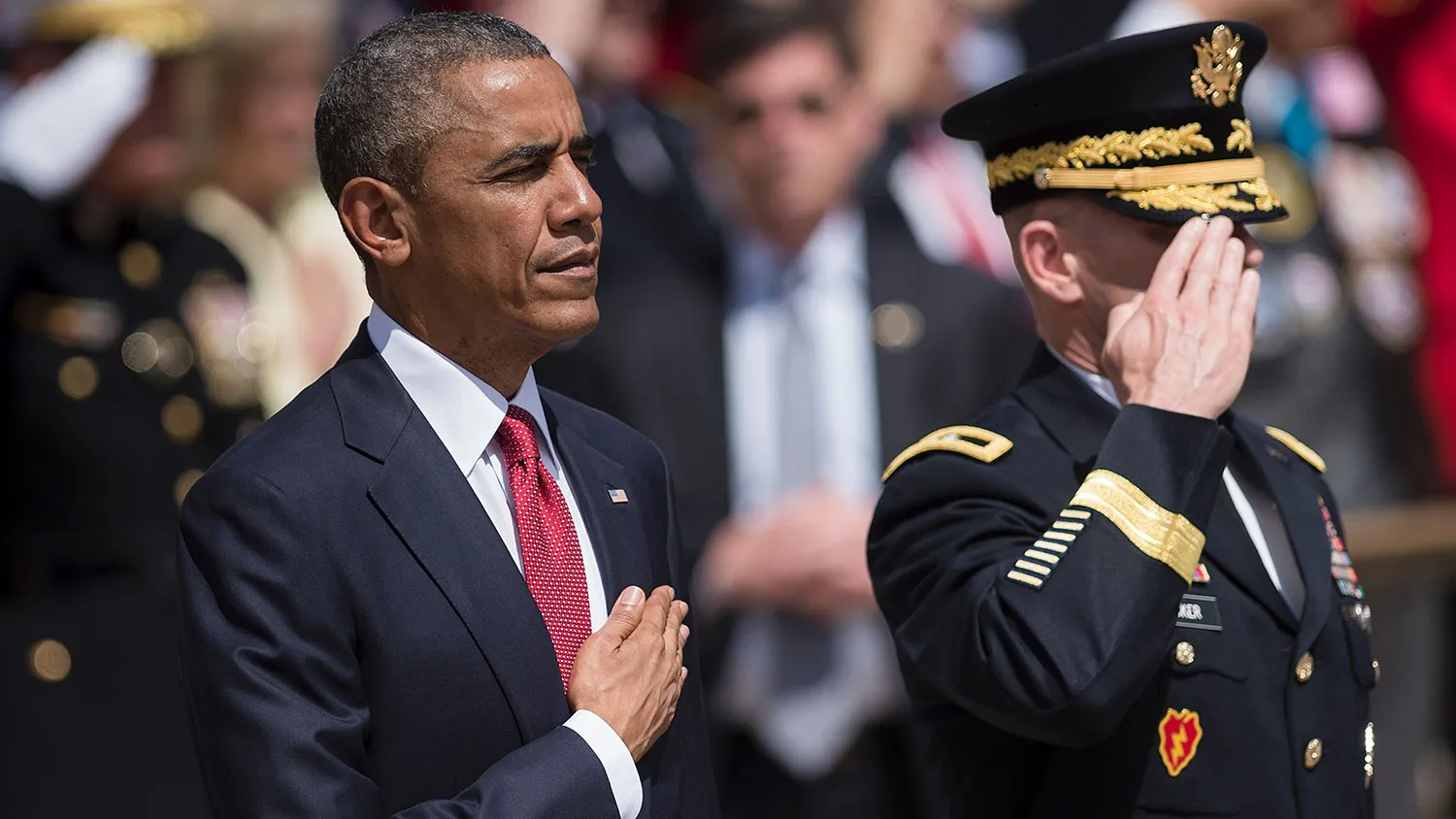 President Barack Obama and U.S. Major General Bradley A. Becker, commander of the military district of Washington, listen to the national anthem before placing a wreath at the Tomb of the Unknowns to honor Memorial Day at Arlington National Cemetery on May 30, 2016, in Arlington, Virginia.
