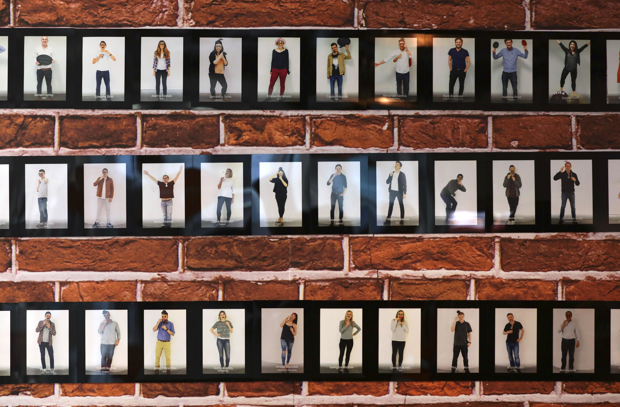Photographs of Funding Circle employees on a wall at the company’s headquarters
