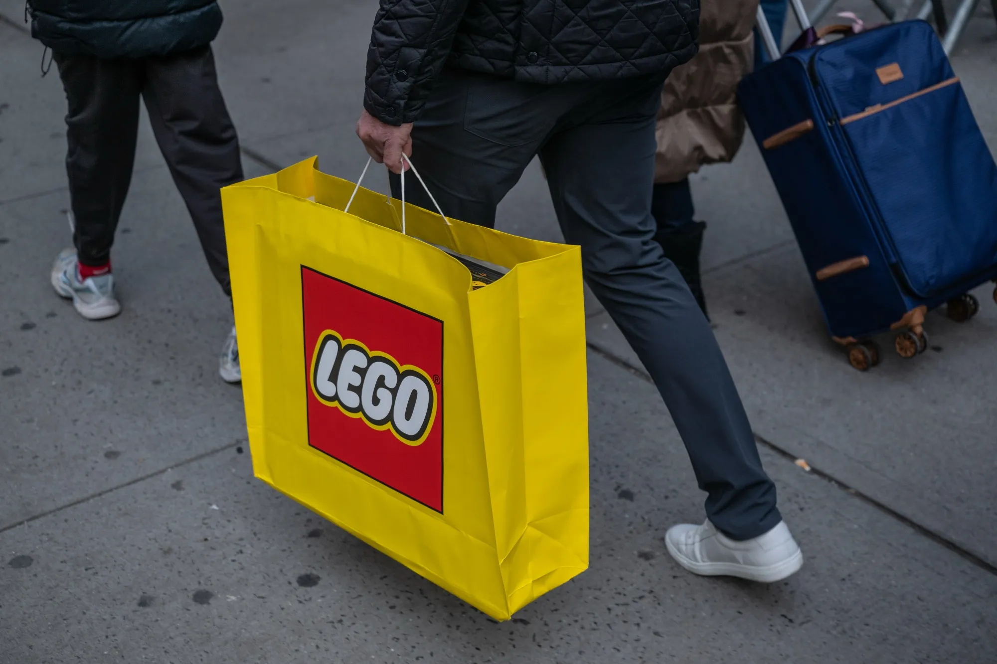 A shopper carries a Lego bag in New York.