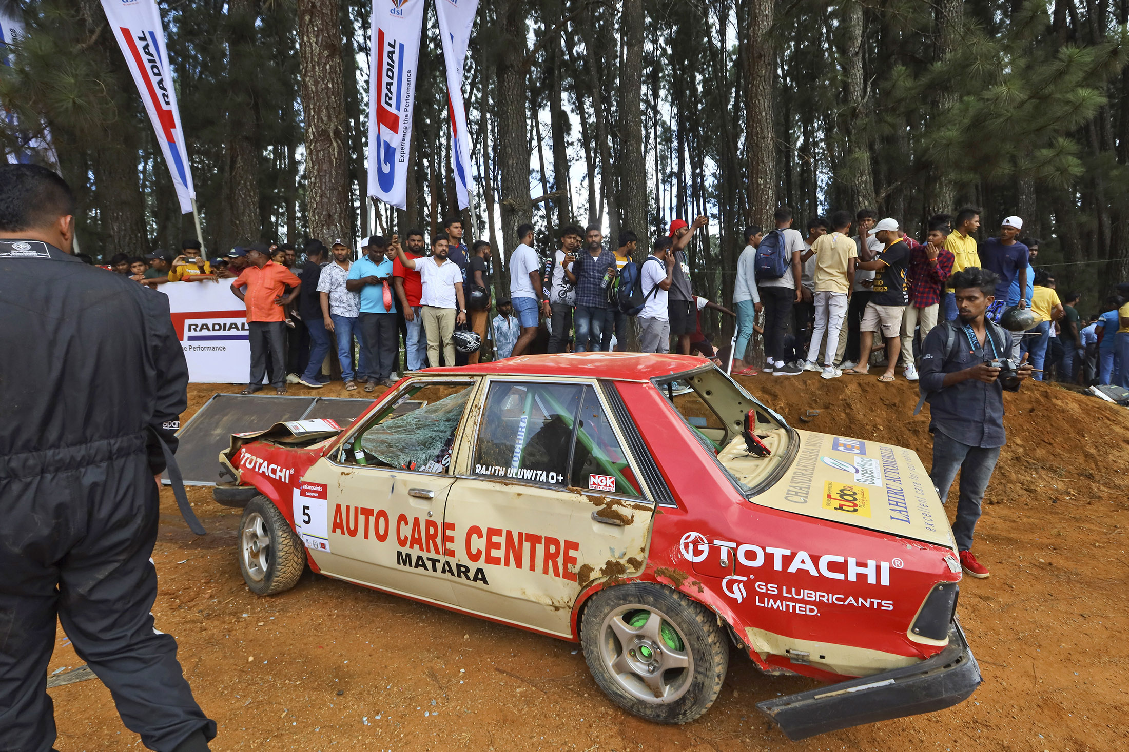 People gather around a car that had crashed into the spectators during the Fox Hill Supercross in Diyatalawa, Sri Lanka, on April 21.