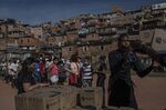Volunteers distribute boxes of food and hygiene materials to residents in the Vale das Virtudes favela of Sao Paulo, Brazil, on June 12.
