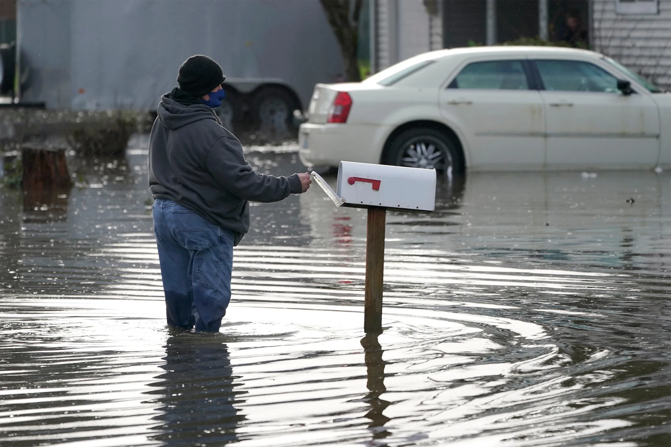 A resident wades through floodwaters in front of his home near Centralia, Wash., on Jan. 7.