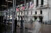 Pedestrians pass in front of the New York Stock Exchange (NYSE) in New York, U.S., on Wednesday, Feb. 26, 2020. U.S. equities swung between gains and losses as investors digested fresh evidence of the widening coronavirus outbreak.