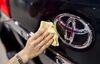 An employee polishes a Toyota Motor Corp. badge on a vehicle at the Toyota Mega Web showroom in Tokyo, Japan, on Tuesday, Aug. 1, 2017. Toyota is scheduled to report first-quarter results on Aug. 4.
