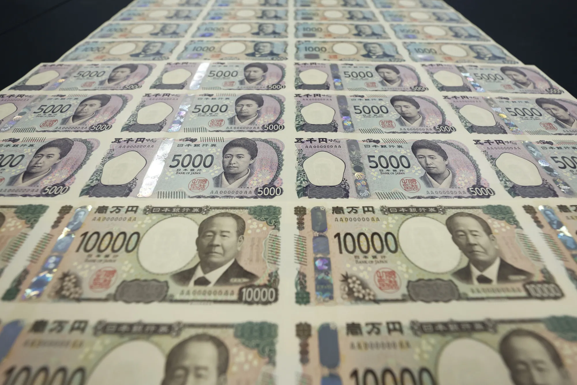 Sheets of newly-designed Japanese yen banknotes at the National Printing Bureau Tokyo plant in Tokyo.