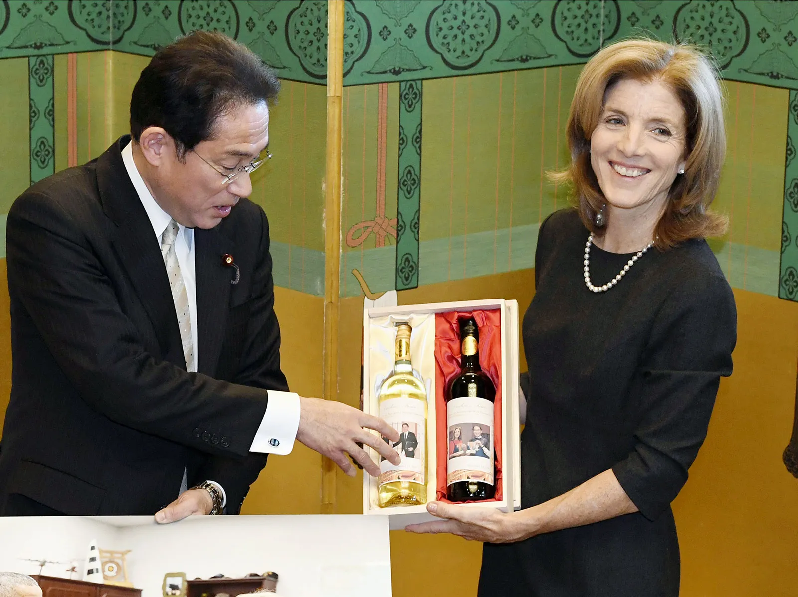 Outgoing U.S. Ambassador to Japan Caroline Kennedy receives bottles of wine as a farewell gift from Japanese Foreign Minister Fumio Kishida in Tokyo.
