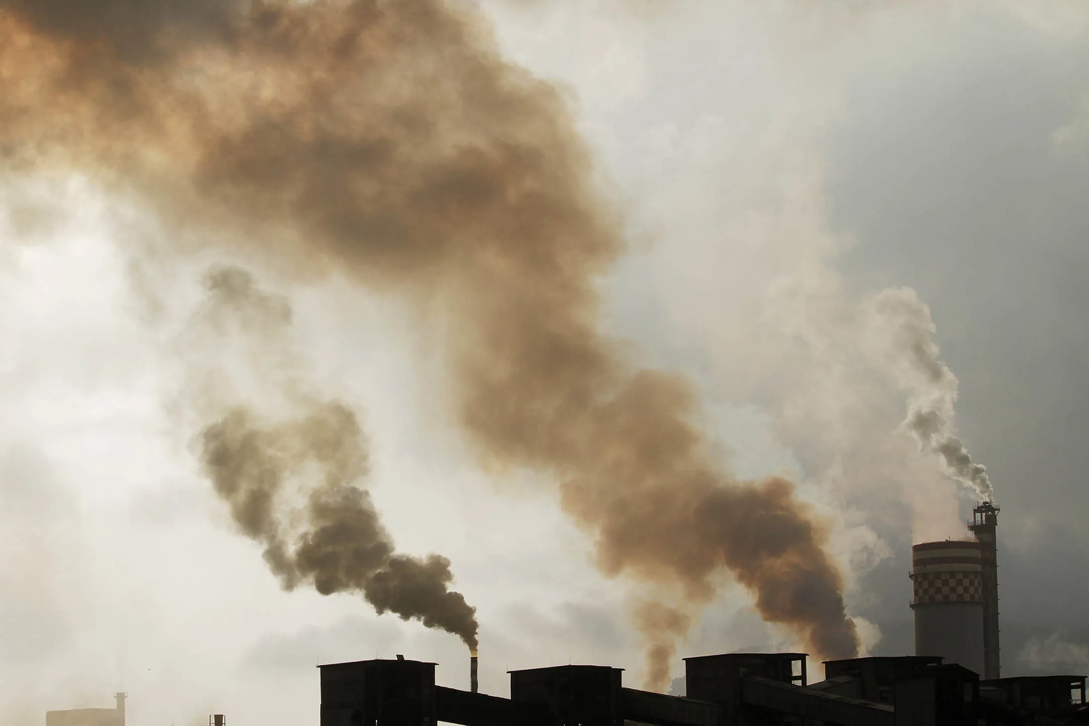 A chemical factory discharges exhaust into the air in Mumbai.
