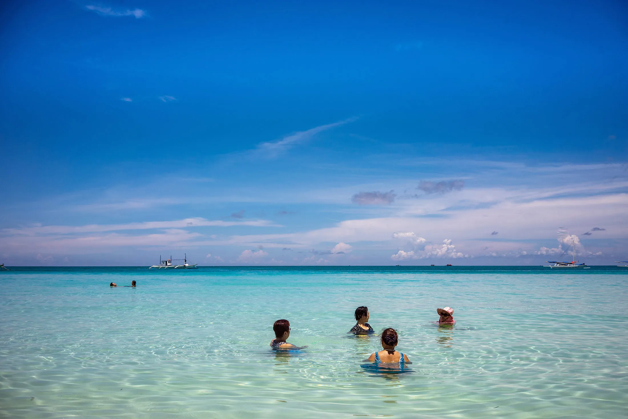 A group of Chinese tourists bathe in the sea at White Beach in Boracay, the Philippines, on July 29, 2015.
