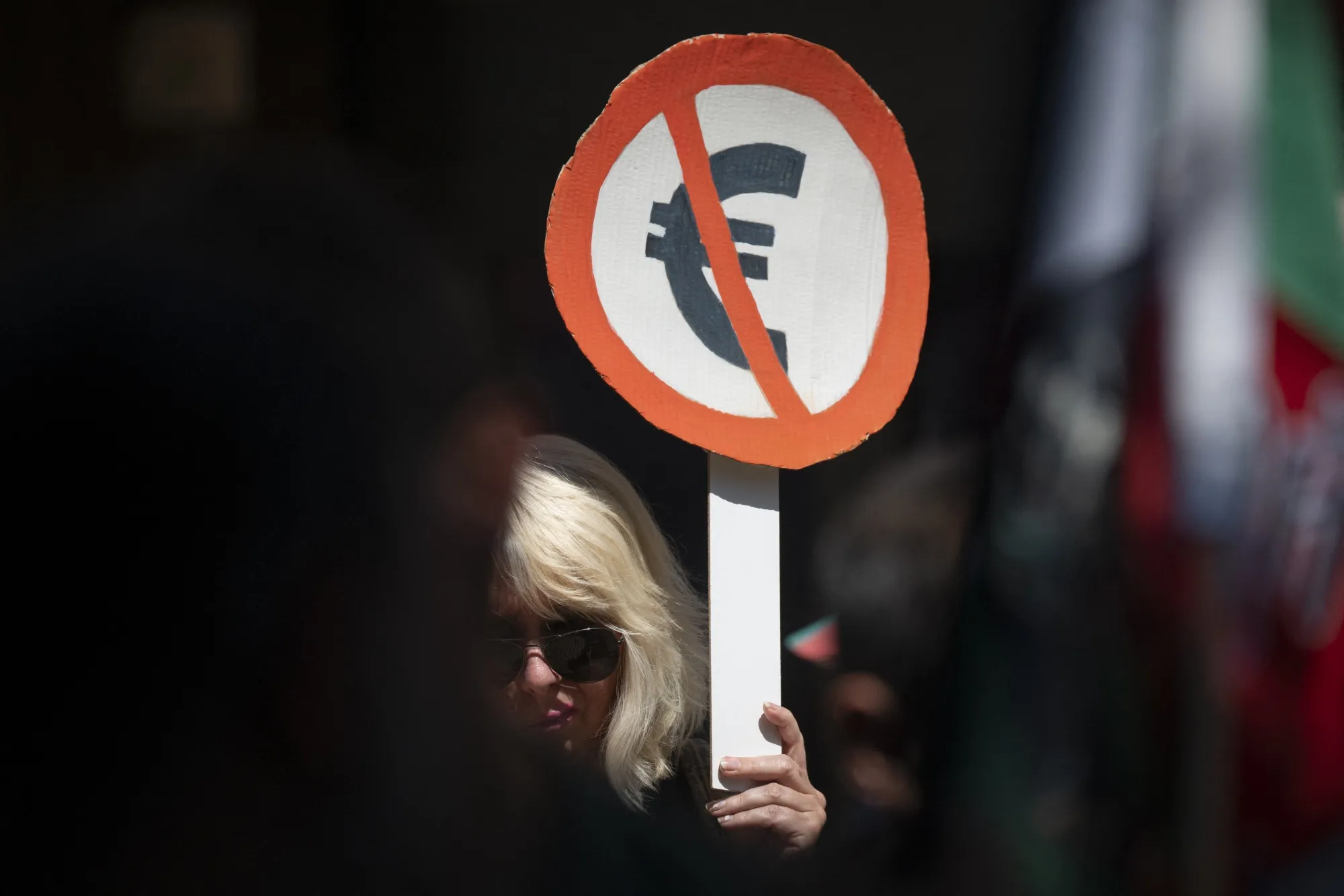 A woman holds a placard during a demonstration against Bulgaria entering the eurozone on June 4.
