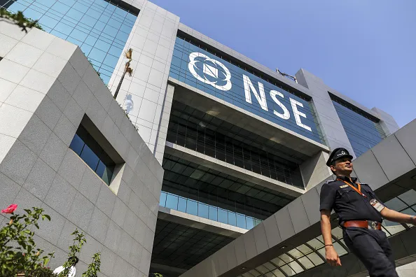 A security guard walks past the National Stock Exchange of India Ltd. (NSE) building in Mumbai, India