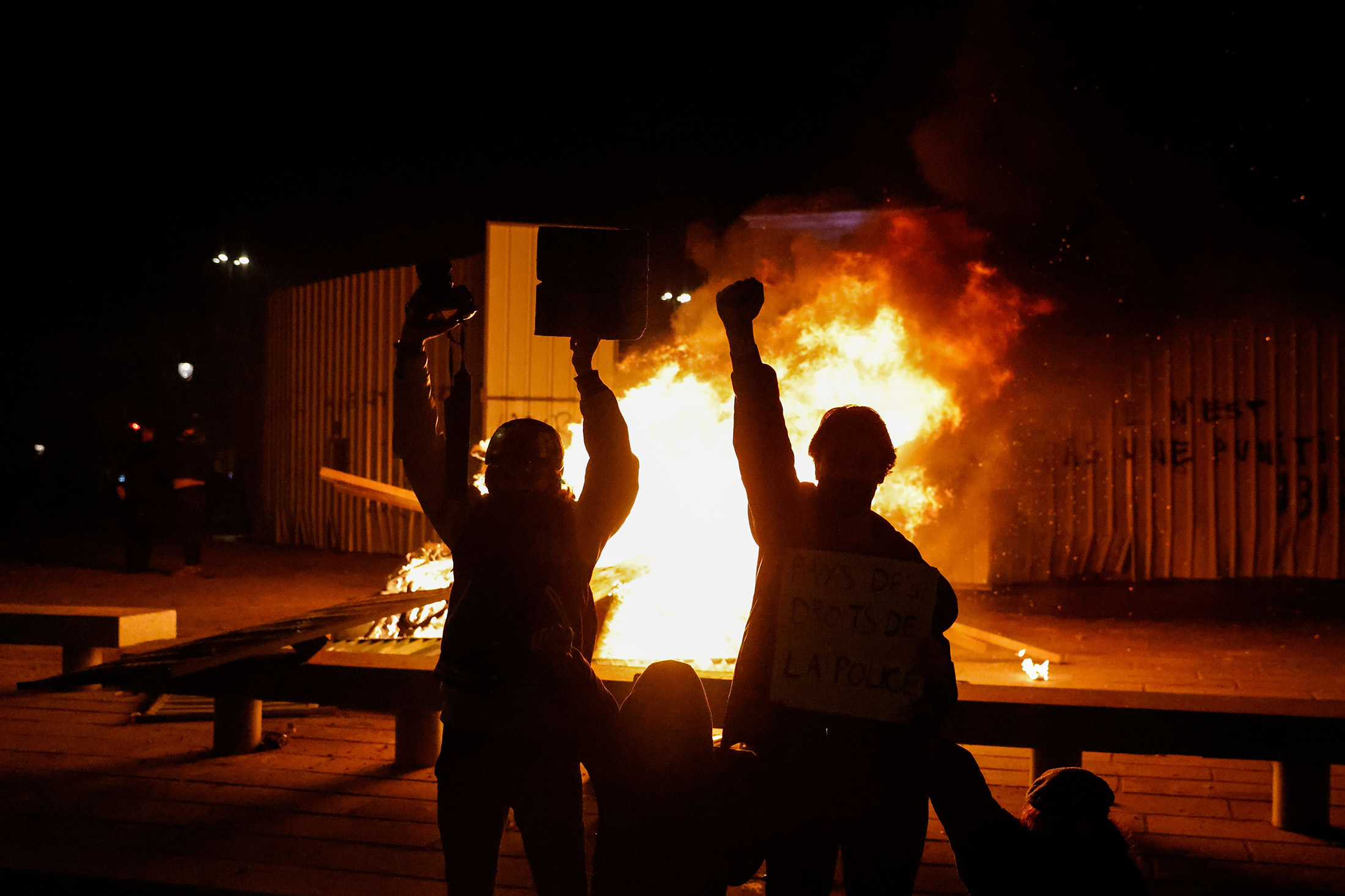 Demonstrators gesture in front of a burning barricade on Place de la Bastille in Paris on Nov. 28.