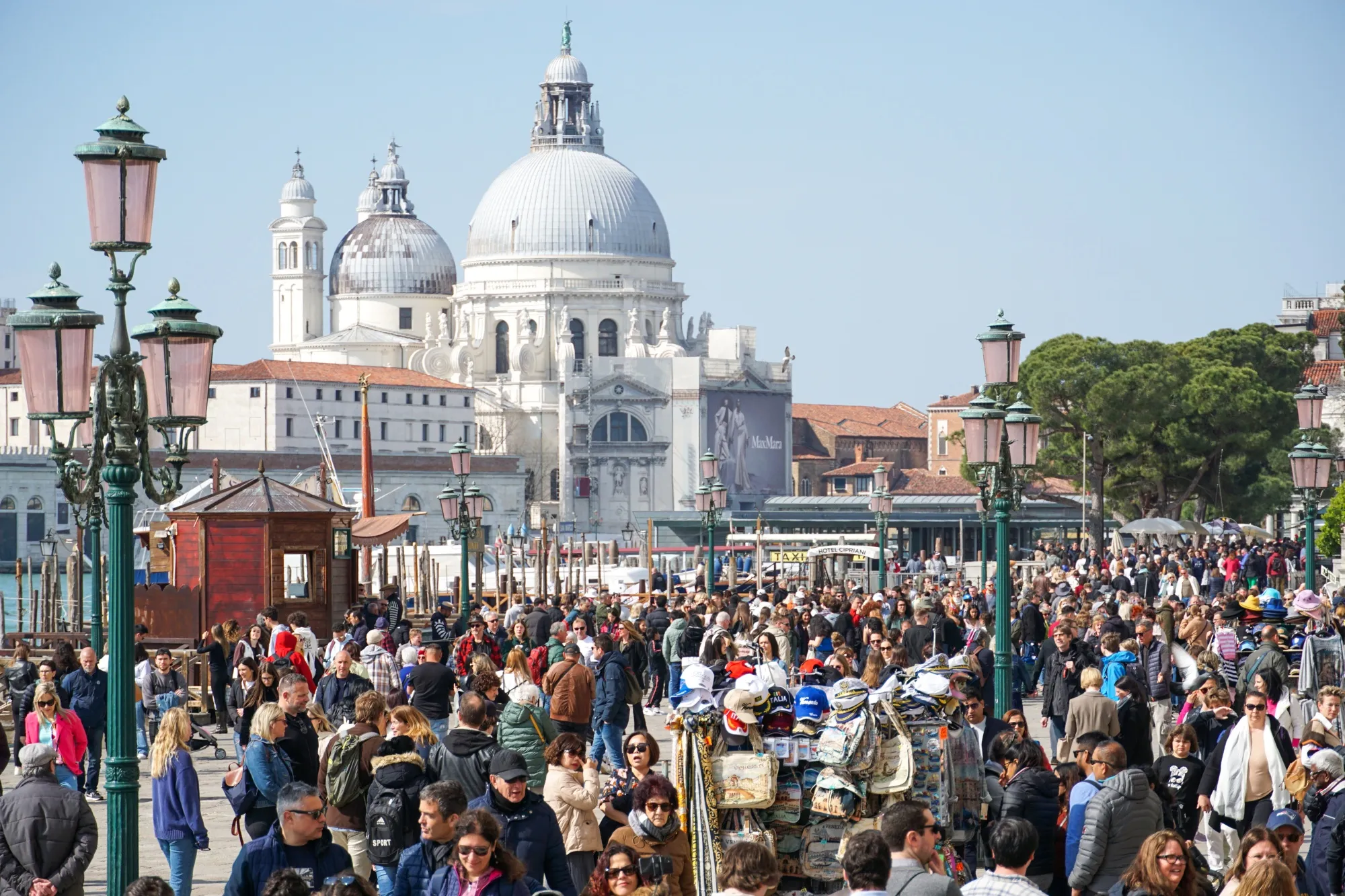 Tourists walk along San Marco pier in Venice, Italy.