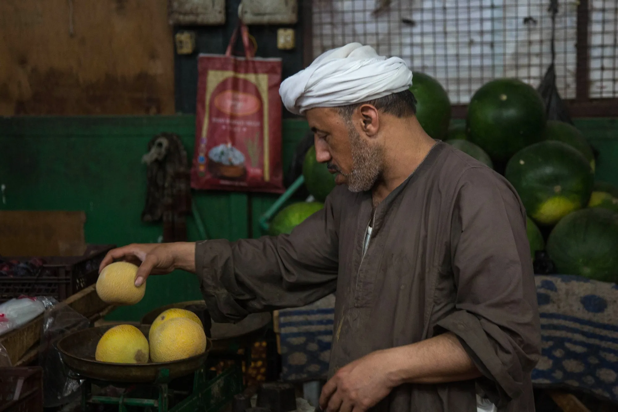 A vendor weighs fruit at the Al-Manhal market in Cairo.