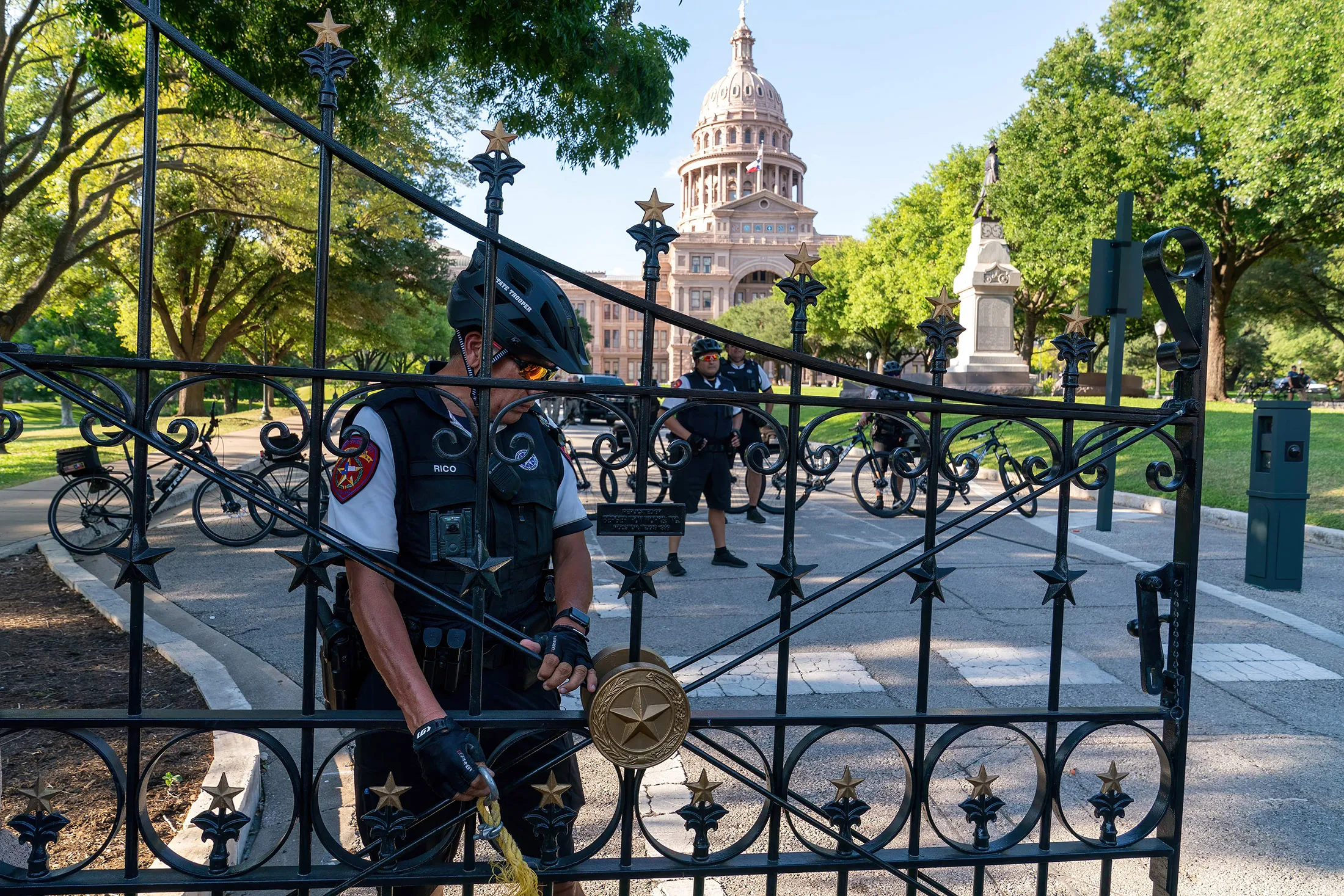 A police officer secures the gate at the State Capitol as abortion rights demonstrators march nearby in Austin, Texas, on June 25.