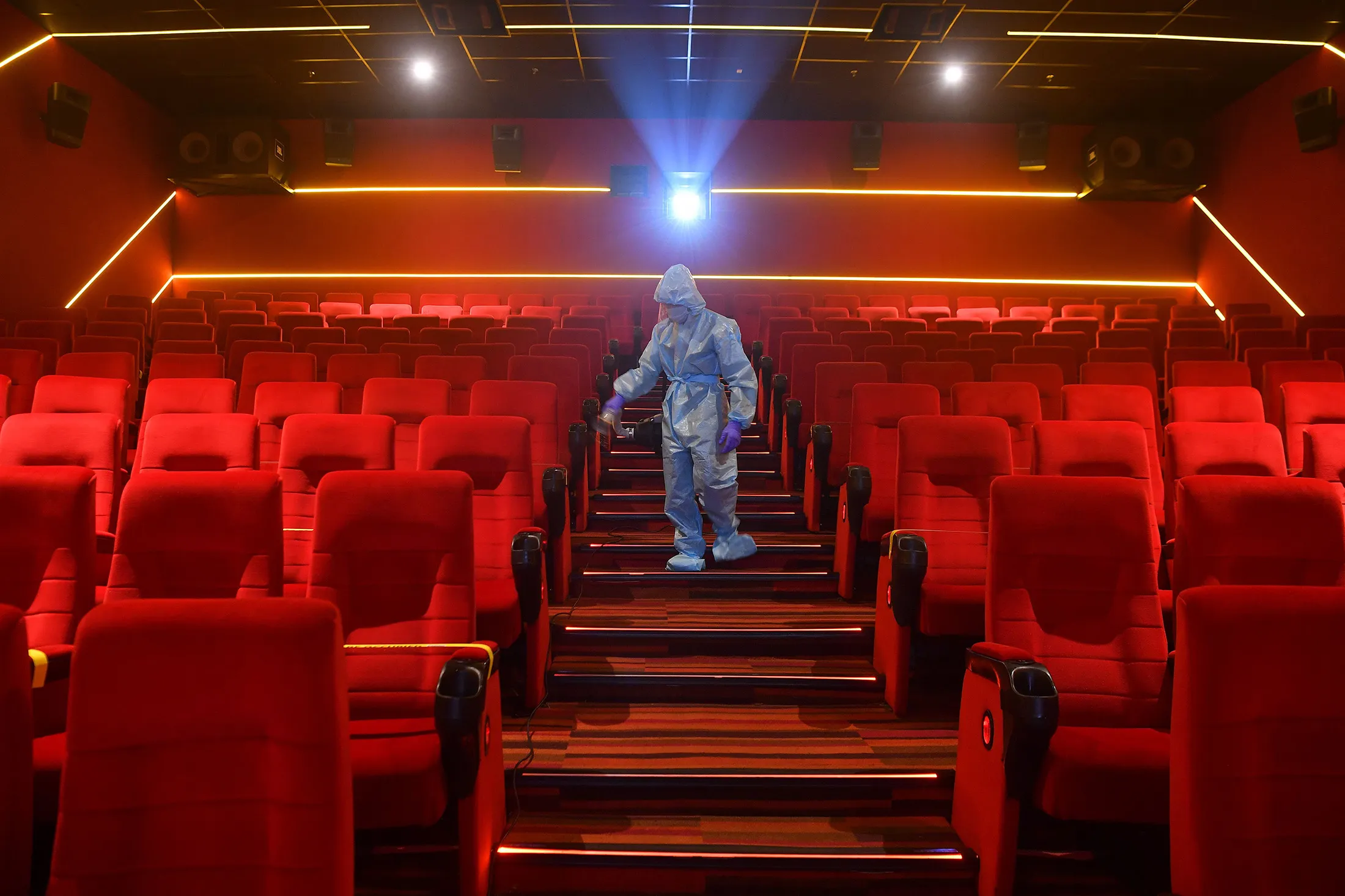 A worker sanitizes a cinema in Mumbai on Oct. 13.