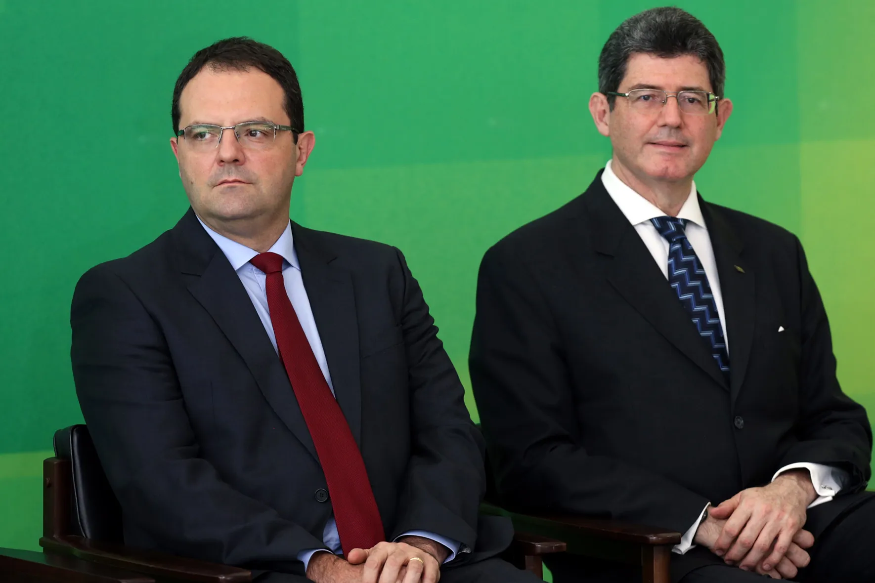 Nelson Barbosa, Brazil's new finance minister, left, sits next to Joaquim Levy, the former finance minister, during his inauguration in Brasilia, Brazil, on Dec. 21.
