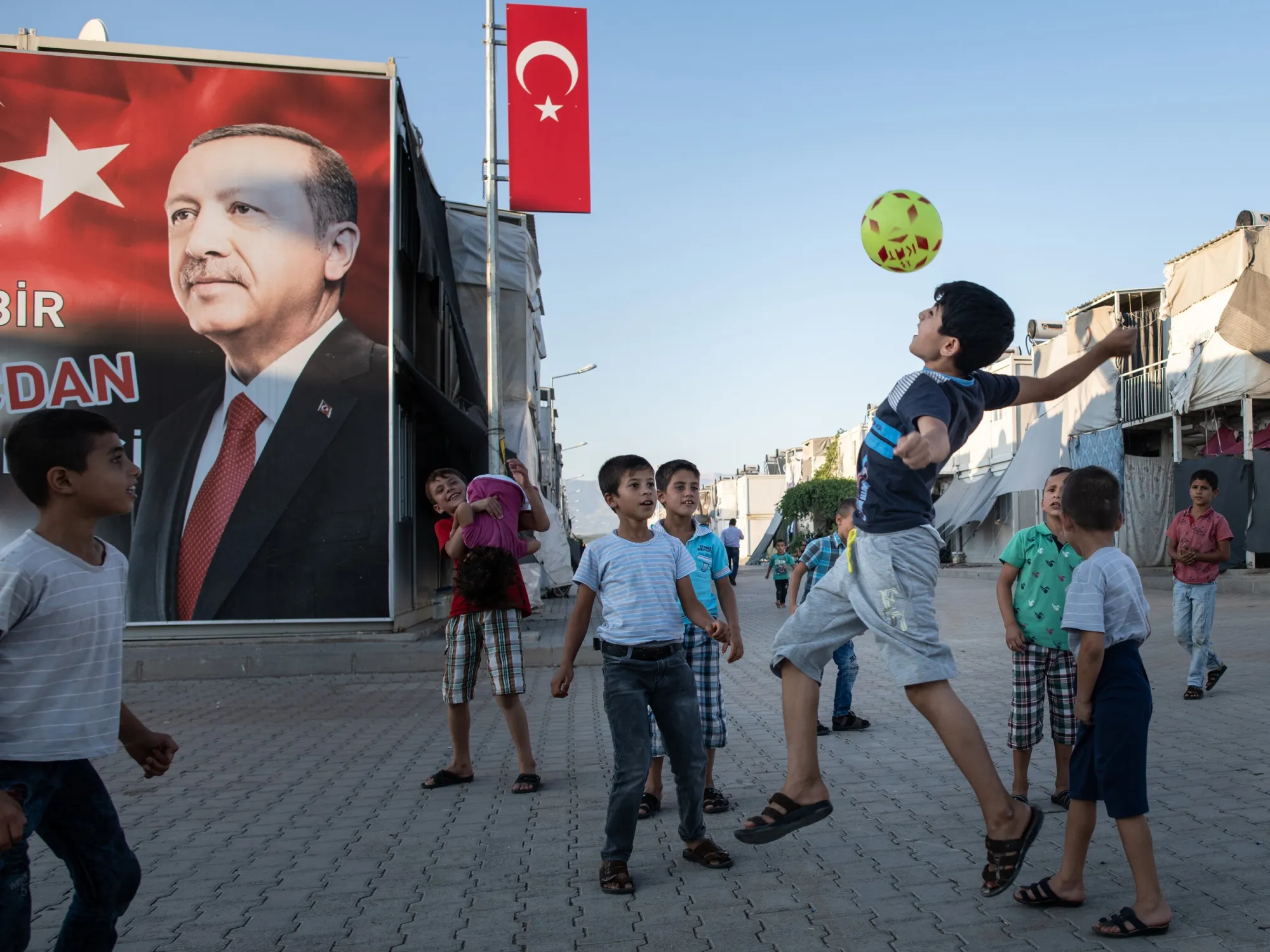 Syrian children play in front of Recep Tayyip Erdogan at the Kahramanmaras refugee camp in Turkey, in September.