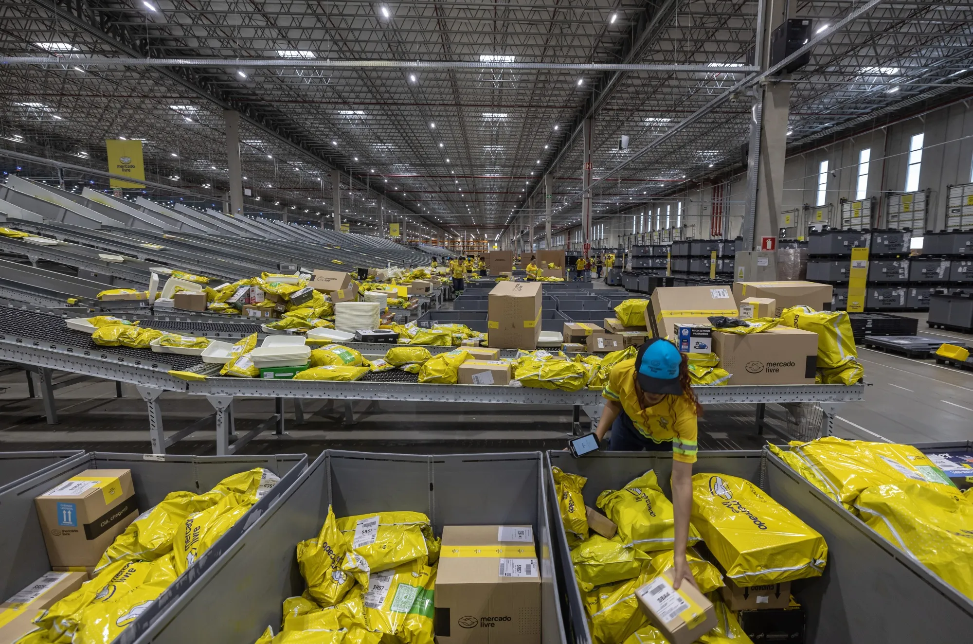 A worker sorts packaged products at the MercadoLibre fulfillment center in Sao Paulo, Brazil.