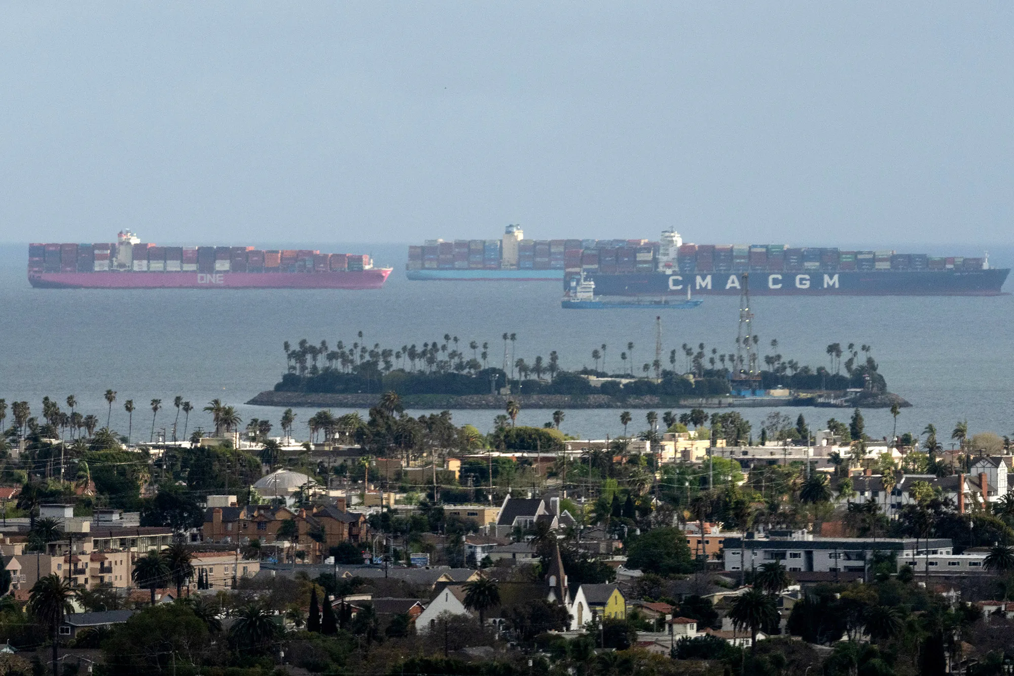Container ships wait offshore at the Port of Long Beach in Long Beach, California, U.S. on Thursday, March 25..&nbsp;