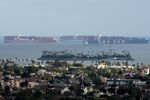 Container ships wait offshore at the Port of Long Beach in Long Beach, California, U.S. on Thursday, March 25..&nbsp;