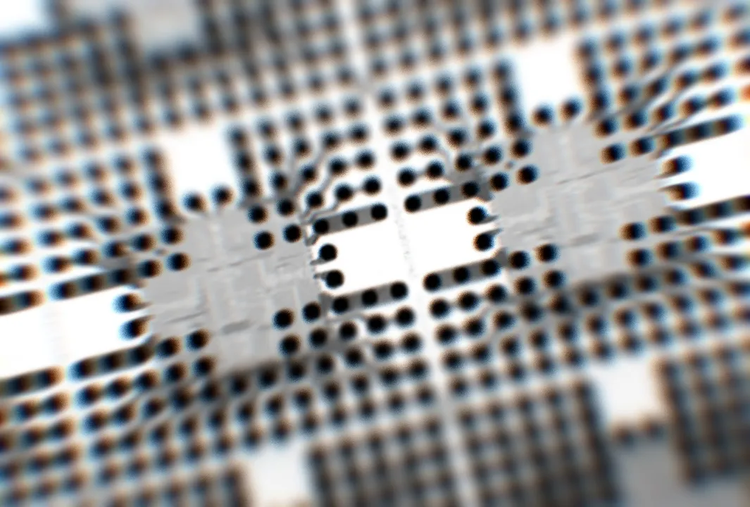 Integrated circuits sit on an Embedded Wafer Level Ball Grid Array (eWLB) circuit board at the Infineon Technologies AG microchip and sensor manufacturing facility in Regensburg, Germany, on Wednesday, Feb. 17, 2016. Infineon designs, manufactures and markets semiconductors for the automotive, industrial, communications, consumer and security electronics sectors.
