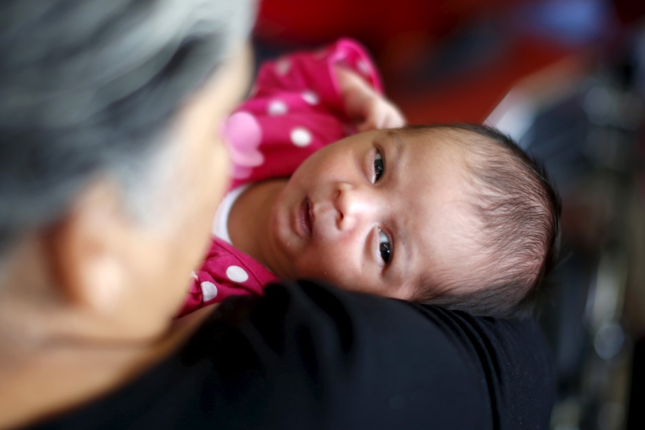 A woman holds her granddaughter at the Care Harbor clinic in Los Angeles, California, October 2015.