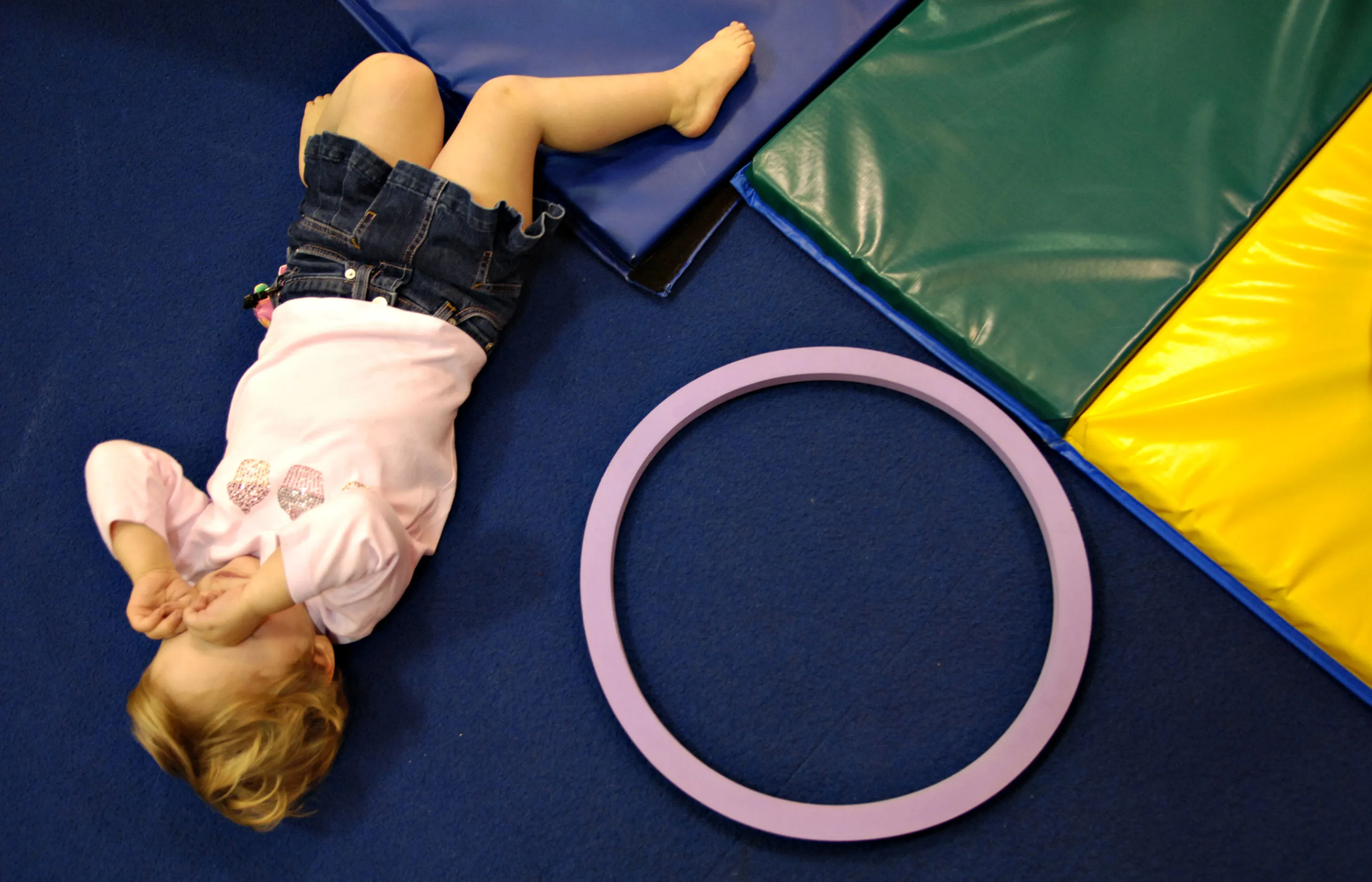 A child in the 'Kidville University' class rubs her eyes during a play time at Kidville in New York Thursday, January 12, 2006.&nbsp;