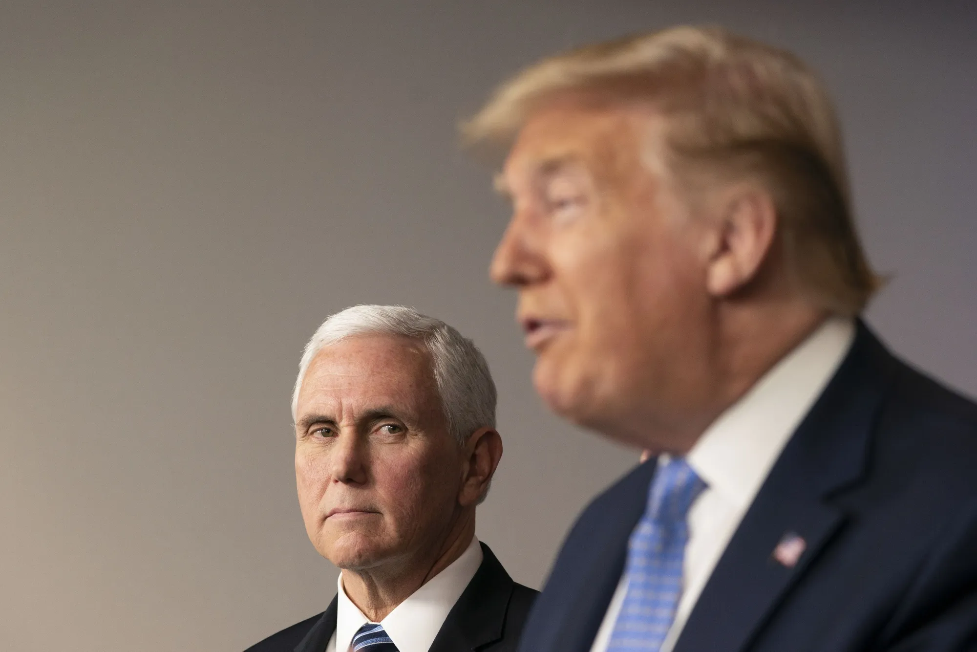 Mike Pence listens as Donald Trump, right, speaks during a news conference in the press briefing room of the White House in Washington, D.C., U.S., on March 15.